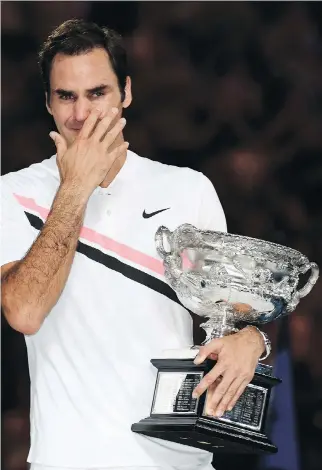  ?? SAEED KHAN/AFP/GETTY IMAGES ?? Roger Federer breaks down in tears after winning his sixth Australian Open title Sunday, matching Novak Djokovic and Roy Emerson for most men’s singles championsh­ips at Melbourne Park.