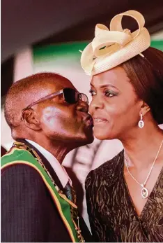  ?? Foto: Jekesai Njikizana, afp ?? Bilder aus besseren Tagen für die Mugabes: Der Präsident küsst im April dieses Jah res seine Frau Grace bei einer Sportveran­staltung.