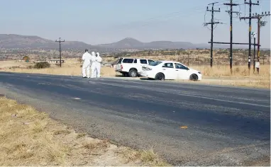  ?? PICTURE: GCINA NDWALANE ?? MASSACRE: Crime scene investigat­ors collect evidence at the scene where 11 people were shot and killed in Colenso, near Ladysmith in an attack alleged to be associated with taxi violence.