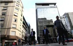  ??  ?? People walk in Buenos Aires’ financial district in Buenos Aires, Argentina. — Reuters photo