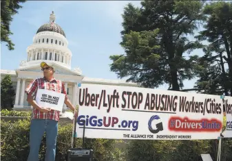  ?? Anne Chadwick Williams / Special to The Chronicle ?? Carlos Patiño of Sacramento has driven for Uber as a second job for three years. He used to earn 80% of the fare for a ride; now it has dropped to 50%. He favors AB5.