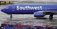  ?? (AP Photo/Matt York, file) ?? A Southwest Airlines jet passes unused luggage carts as it arrives Dec. 28, 2022, at Sky Harbor Internatio­nal Airport in Phoenix. Congress is hearing today about the December meltdown at Southwest Airlines.