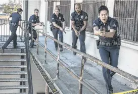  ??  ?? David Lim, from right, Shemar Moore, Kenny Johnson, Jay Harrington and Lina Esco star in the police drama “S.W.A.T.”
