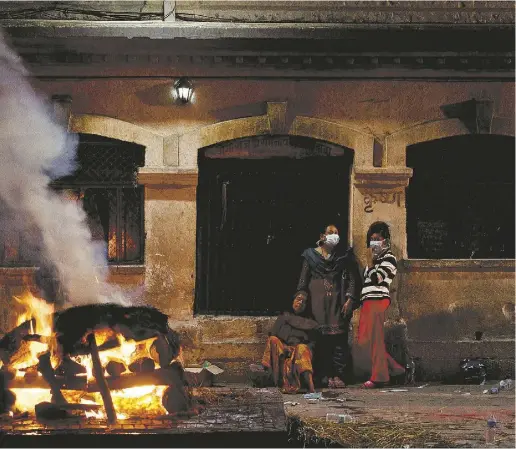  ?? MANAN VATSYAYANA / AFP / Getty
Imag
es ?? Nepalese women mourn during the cremation of an earthquake victim on the banks of Bagmati River at the Pasupathin­ath
temple in Kathmandu on Wednesday. The United Nations has appealed for US$415 million in relief for Nepal.