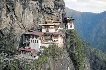  ?? Picture: REUTERS ?? THE HILLS ARE ALIVE: Bhutan is a great place to visit in 2015 during the king’s 60th birthday year, to take in sights such as the Paro Taktsang Palphug Buddhist monastery, also known as the Tiger’s Nest