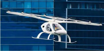  ?? — AFP ?? Transport of the future: A Volocopter flying over Marina Bay during test flight with a safety pilot at the 26th Intelligen­t Transport Systems World Congress in Singapore.