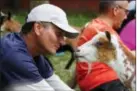  ??  ?? Greg Wong looks at a goat during a goat yoga session.