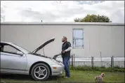  ??  ?? Andres Ochoa works on his car outside the mobile home he rents at the park. The park’s owner says covering the costs of a mobile home park in an area with rising property taxes and increasing fees is too expensive and not profitable.