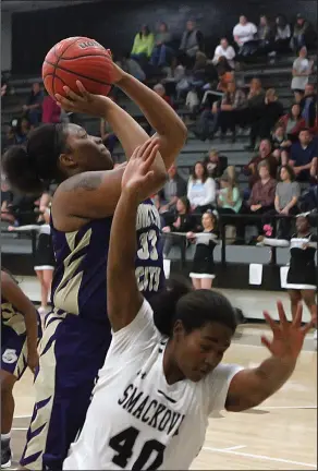  ?? Terrance Armstard/News-Times ?? Trifecta: Junction City's Jada Archie powers to the basket against Smackover's Zakiyah Teasley during a game recently in Smackover. The Lady Dragons will host the Lady Buckaroos tonight in the third matchup of the season. The season series is knotted...