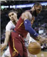  ?? CHARLES KRUPA — THE ASSOCIATED PRESS ?? Cleveland’s LeBron James loses the ball as he is pressured by Boston’s Jayson Tatum during Game 2 of the Eastern Conference finals in Boston om Tuesday.