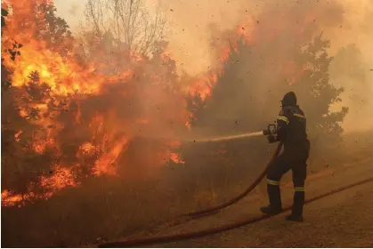  ?? ?? A firefighte­r tries to extinguish a wildfire in Evros, Greece, on 31 August 2023. Photograph: Ayhan Mehmet/Anadolu via Getty Images