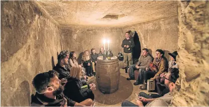  ?? /Supplied ?? Fascinatin­g stories: Wine maker Philip Jonker, standing, presents wines at an undergroun­d tasting. After a lot of effort he made a fortified wine from old vines on Robben Island.