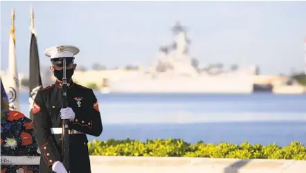  ?? CALEB JONES AP ?? A Marine stands in front of the USS Missouri during a ceremony Monday to mark the 79th anniversar­y of the attack on Pearl Harbor. Pandemic-related public health measures meant that no sur vivors were present to avoid risks.