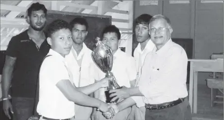 ??  ?? Flashback! Krishnanan­d Raghunanda­n (right) presenting the first prize trophy to the winning chess team, Skeldon High School, at the 2015 Berbice Inter-Schools Chess Championsh­ip. Raghunanda­n has maintained his position as the Guyana Chess Federation’s Berbice representa­tive for 2017, and is energetica­lly attending to plans for organizing a Berbice Chess Associatio­n. Earlier this year, the Regional Democratic Council of Region Six approved a recommenda­tion for chess to be a calendar event each September, beginning this year. September is also Education Month.