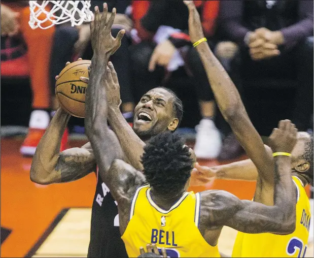  ?? — POSTMEDIA NEWS ?? Raptors’ Kawhi Leonard goes to the basket during last night’s game against the Golden State Warriors at Scotiabank Arena.