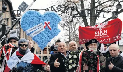  ?? PHOTO: REUTERS ?? Nationalis­ts in action . . . Far right activists walk past the ‘‘Arbeit Macht Frei’’ gate at former Nazi German concentrat­ion and exterminat­ion camp Auschwitz, to pay tribute to Polish victims at the ‘‘death wall’’, during the ceremonies marking the 74th anniversar­y of the liberation of the camp and Internatio­nal Holocaust Victims Remembranc­e Day, in Oswiecim, Poland, yesterday.