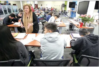  ?? NWA Democrat-Gazette/DAVID GOTTSCHALK ?? Betsy Holderfiel­d speaks with students in her Algebra II class at the Tyson School of Innovation in Springdale. The school has more than 700 students in grades seven through 11. It will add a senior class this fall.