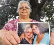  ?? JOSHUA REPLOGLE / AP ?? Susan Bro, Heather Heyer’s mother, holds a photo of Bro’s mother and her daughter, Monday in Charlottes­ville, Va. Heyer was killed Saturday, when police say a man plowed his car into a group protesting a white nationalis­t rally. Bro said that she is...