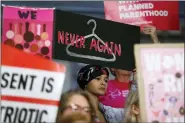  ?? CHARLIE NEIBERGALL, FILE - THE ASSOCIATED PRESS ?? In this May 21file photo, August Mulvihill, of Norwalk, Iowa, center, holds a sign during a rally to protest recent abortion bans at the Statehouse in Des Moines, Iowa. A new report released Wednesday, Sept. 18, shows that the number and rate of abortions across the U.S. have plunged to their lowest levels since the procedure became legal nationwide in 1973.