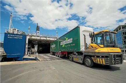  ??  ?? A Freight Lines B-train unloads from Strait Shipping’s Straitsman at CentrePort in Wellington.