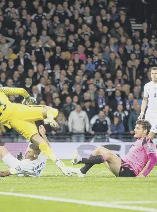  ??  ?? 1 Slovakia captain Martin Skrtel stretches to clear Ikechi Anya’s cross under pressure from Chris Martin but can only turn it into his own net. 2 Robert Mak dives as he is challenged by Craig Gordon, earning a second yellow card and a 22nd-minute...