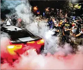  ?? COURTESY OF BEN HENDREN ?? A large crowd gathers towatch cars do burnouts in Atlanta. Police data show911 calls that mentioned “racing,” “drag” or “donuts” have increased steadily since June, with 551 calls lastmonth that included those terms.