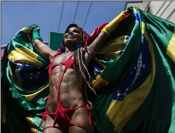  ?? PHOTOS BY BRUNA PRADO — THE ASSOCIATED PRESS ?? A reveler stands on stilts during the Carmelitas street party on the first day of Carnival in Rio de Janeiro, Brazil, Friday, Feb. 17, 2023.