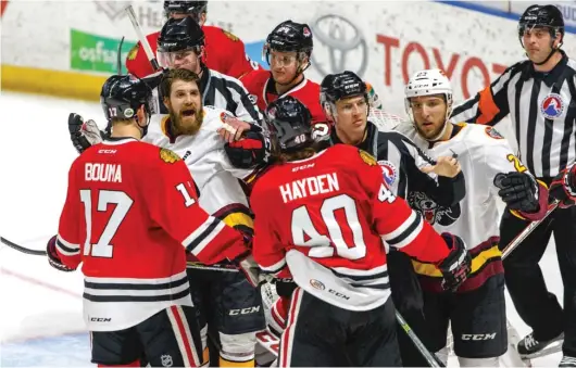  ?? TODD REICHER/ ICEHOGS ?? The Wolves and IceHogs, who will square off in a best- of- five first- round series starting Saturday, have engaged in numerous brawls over the years.
