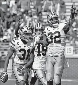  ?? SUE OGROCKI/AP ?? Kansas State’s Jahron McPherson (31) celebrates with teammates after an intercepti­on to seal the win Saturday.