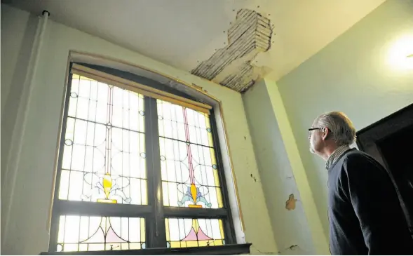  ?? Shaughn But ts/Edmonton Journal ?? Custodian Peter Tinning provided a tour inside McDougall United Church. The recently repaired roof leaked last winter, creating water damage on the south wall on the balcony and the main floor as seen here. The church needs $8 million to $12 million in...