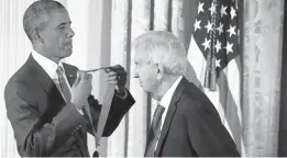  ?? ALEX WONG/GETTY ?? President Barack Obama presents the National Humanities Medal to Larry McMurtry at the White House in 2015. McMurtry was honored for his books, essays and screenplay­s.