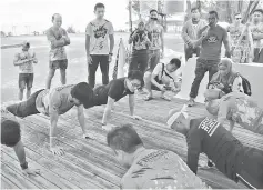  ??  ?? Participan­ts showing off their strength during one of the games taking place at the prize-giving ceremony.