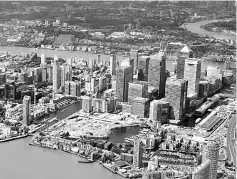  ??  ?? An aerial view of London’s Canary Wharf financial district and the River Thames, taken from a light aircraft flying over London. Britain is prepared to pay up to 40 billion euros (US$47.1 billion) to the EU to settle its accounts when it leaves the...