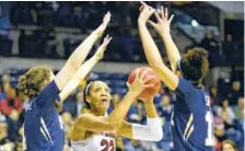  ?? THE ASSOCIATED PRESS ?? South Carolina forward A'ja Wilson, center, goes to the basket between Quinnipiac's Paula Strautmane, left, and Sarah Shewan during an NCAA tournament regional semifinal Saturday in Stockton, Calif.