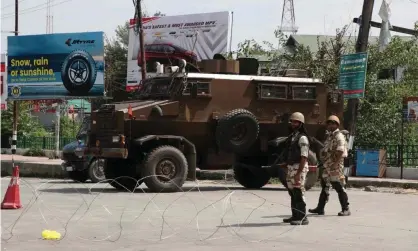  ??  ?? Indian security forces guard a street in Srinagar, Kashmir, where movement has been restricted. Photograph: Saqib Mugloo/AFP/Getty Images