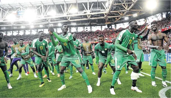  ?? /MICHAEL REGAN/GETTY IMAGES ?? Senegal players celebrate after their 2-1 victory in the Group H match against Poland on Tuesday at Spartak Stadium. The team has proved to be Africa’s saving grace in the opening games of the soccer showpiece.