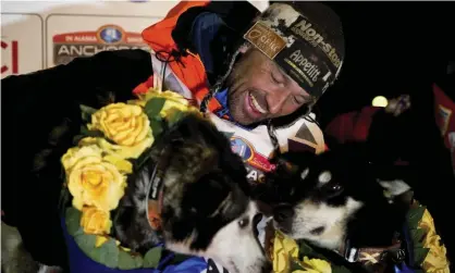  ??  ?? Thomas Waerner with two of his dogs after finishing this year’s race in Nome, Alaska. Photograph: Marc Lester/AP