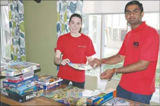  ??  ?? Mohawk student volunteers, Holly Scime (left) and Ravi Patel (right) set up for games night at RMCHSCO.