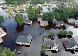  ?? JASON MICZEK /REUTERS ?? Houses sit in floodwater caused by Hurricane Florence, in this aerial picture, in Lumberton, North Carolina on Monday.