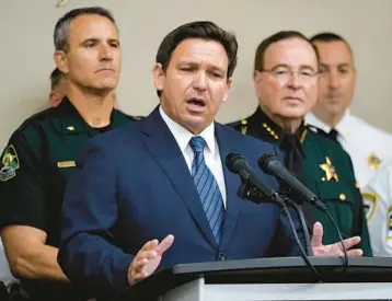  ?? CHRIS O’MEARA/AP ?? Gov. Ron DeSantis gestures as he speaks in Tampa during an Aug. 4 news conference in which he announced he was suspending State Attorney Andrew Warren, of the 13th Judicial Circuit, due to what he said was“neglect of duty.”Warren is among the eight elected officials DeSantis has suspended who have not been charged with crimes.