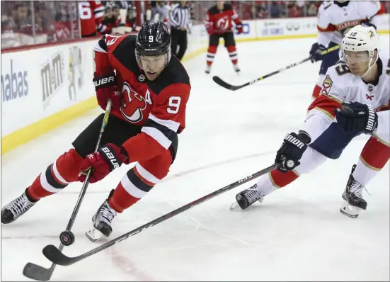  ?? MARY ALTAFFER — THE ASSOCIATED PRESS ?? Devils left wing Taylor Hall (9) skates against Panthers defenseman Mike Matheson (19) during the second period of Monday’s game in Newark.
