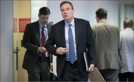  ?? J. SCOTT APPLEWHITE — ASSOCIATED PRESS ?? Senate Intelligen­ce Committee Vice Chairman Mark Warner, D-Va., emerges from behind closed doors Wednesday on Capitol Hill after members of the Senate Intelligen­ce Committee met with former national security chiefs about the probe of Russian's meddling...