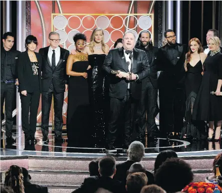  ?? NBC ?? Writer-producer Bruce Miller accepts the award for best TV drama series along with the cast and crew of The Handmaid’s Tale on Sunday night at the 75th annual Golden Globe Awards. The series is based on Canadian Margaret Atwood’s book of the same name.