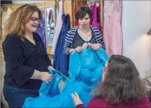  ?? WILLIAM HARVEY/TRILAKES EDITION ?? Discussing a possible prom dress are Hannah White, from left, Kelsey Heffner and Candie Jo Butler, all residents of the Arkadelphi­a Human Developmen­t Center. Staff and community members have donated more than 300 ball gowns for the center’s upcoming...