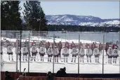  ?? RICH PEDRONCELL­I — THE ASSOCIATED PRESS ?? Members of the Colorado Avalanche, foreground and the Vegas Golden Knights, background lineup for the national anthem at the Outdoor Lake Tahoe game in Stateline, Nev., on Saturday.