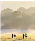  ?? ?? Walkers enjoy a frosty and misty sunrise in Richmond Park, London, yesterday