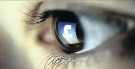  ??  ?? A picture illustrati­on shows a Facebook logo reflected in a person’s eye. Facebook has been fined by a French data protection watchdog.