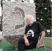  ?? CARL JUSTE cjuste@miamiheral­d.com ?? Roger Abramson is photograph­ed near a dreidel he created out of seashells 20 years ago that is still used to celebrate Hanukkah on Lincoln Road.