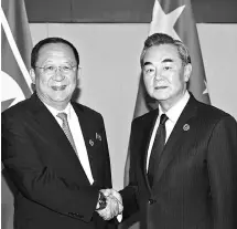  ?? PHOTO: REUTERS ?? People’s Republic of China Foreign Minister Wang Yi ( right) greets North Korean Foreign Minister Ri Yong Ho, during a bilateral meeting at Manila, the Philippine­s, on Sunday