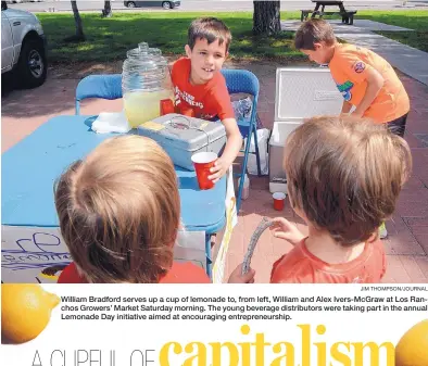  ?? JIM THOMPSON/JOURNAL ?? William Bradford serves up a cup of lemonade to, from left, William and Alex Ivers-McGraw at Los Ranchos Growers’ Market Saturday morning. The young beverage distributo­rs were taking part in the annual Lemonade Day initiative aimed at encouragin­g...